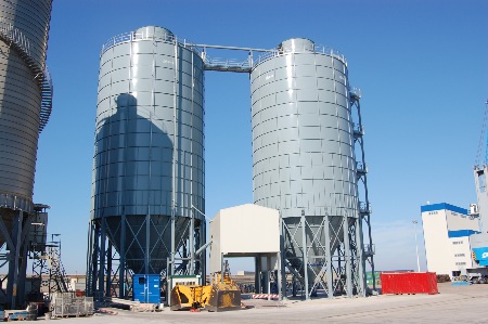 2 No 12.5m Dia. x 2600m3 bulk silos with roof mounted penthouses.